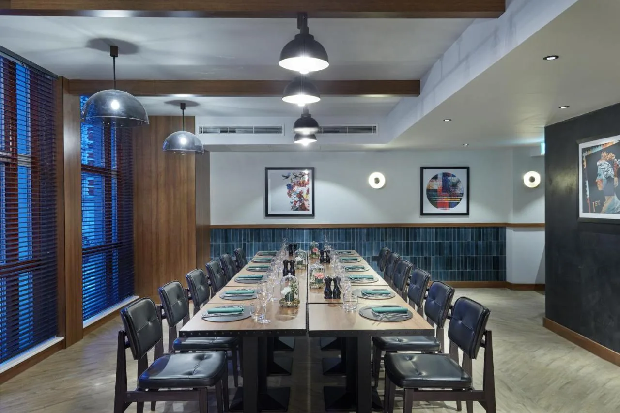 a large conference room with a long table and chairs at NYX Hotel London Holborn by Leonardo Hotels in London